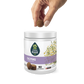 Hand holding a chew, hovering over a container of EverRoot Calming Soft Chews
