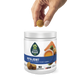 Hand holding a chew, hovering over a container of EverRoot hip and joint soft chews